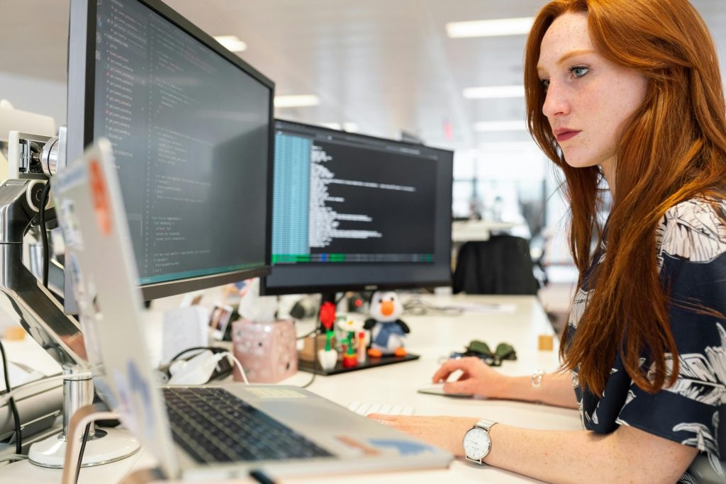 a woman examining the technical SEO health of her website via a dashboard